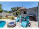 Backyard featuring a fire pit, Adirondack chairs, and lush tropical landscaping at 1503 Albemarle Ct, Dunedin, FL 34698