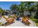 Charming backyard firepit with Adirondack chairs at 1503 Albemarle Ct, Dunedin, FL 34698