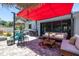 Tropical backyard with a patio area, lounge seating, and lush landscaping at 1503 Albemarle Ct, Dunedin, FL 34698
