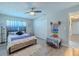 Inviting bedroom with a ceiling fan, wood floors, and white closet doors at 1503 Albemarle Ct, Dunedin, FL 34698