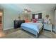 Bedroom featuring a ceiling fan, a dark dresser, and a comfortable bed with wood floors at 1503 Albemarle Ct, Dunedin, FL 34698