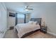 Bedroom featuring a ceiling fan, modern gray walls, and light-colored wood flooring at 1503 Albemarle Ct, Dunedin, FL 34698