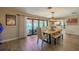 Bright dining room featuring a wooden dining table, floor-to-ceiling windows, and light wood flooring at 1503 Albemarle Ct, Dunedin, FL 34698
