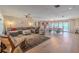 Spacious living room featuring a large sectional sofa and dining area at 1503 Albemarle Ct, Dunedin, FL 34698