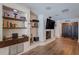 Cozy living room boasting a stone fireplace, built-in shelves, and wood flooring at 1503 Albemarle Ct, Dunedin, FL 34698