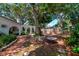 Beautiful backyard featuring mature landscaping, charming brick pathway, and comfortable outdoor seating at 1514 Florida Ave, Palm Harbor, FL 34683