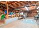 Unfinished basement with open ceiling and Colts logo, offering potential at 1514 Florida Ave, Palm Harbor, FL 34683