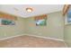 Bright bedroom with tile flooring, window, and fresh paint, creating a comfortable space at 1514 Florida Ave, Palm Harbor, FL 34683
