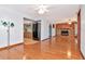 Spacious living room featuring hardwood floors, wood-burning fireplace, and access to the kitchen at 1514 Florida Ave, Palm Harbor, FL 34683