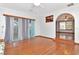 Bright living room with hardwood floors and an arched doorway, perfect for entertaining at 1514 Florida Ave, Palm Harbor, FL 34683