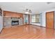 Warm living room featuring hardwood floors, fireplace and ceiling fan at 1514 Florida Ave, Palm Harbor, FL 34683