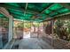 Relaxing screened patio with stone floors, ceiling fan, and views of the backyard at 1514 Florida Ave, Palm Harbor, FL 34683