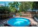 This inviting backyard features a cozy above-ground pool and a wooden deck, perfect for relaxation and outdoor enjoyment at 1514 Florida Ave, Palm Harbor, FL 34683