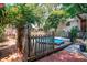 A charming backyard features an above-ground pool and a quaint wooden deck area, offering a serene escape at 1514 Florida Ave, Palm Harbor, FL 34683