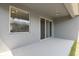 A covered back patio with sliding glass doors leads to a grassy yard at 15711 Starling Dale Ln, Lithia, FL 33547