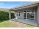 An expansive outdoor patio leads to a green and grassy backyard at 15711 Starling Dale Ln, Lithia, FL 33547