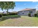 Expansive backyard featuring lush lawn, mature landscaping, and screened-in patio; ideal for outdoor living at 15711 Starling Dale Ln, Lithia, FL 33547