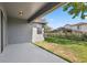 An outdoor space features green grass and a covered patio at 15711 Starling Dale Ln, Lithia, FL 33547
