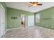 Bright bedroom with wood-look floors, and a glimpse into the en-suite bathroom offers ample space at 15711 Starling Dale Ln, Lithia, FL 33547