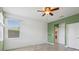 Inviting bedroom with wood-look floors, offering natural light and convenient closet access at 15711 Starling Dale Ln, Lithia, FL 33547