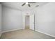 A neutral bedroom boasts tile flooring and an open door at 15711 Starling Dale Ln, Lithia, FL 33547