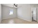 This bedroom is bright with tile floors, a ceiling fan and a doorway at 15711 Starling Dale Ln, Lithia, FL 33547