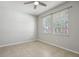 Bedroom featuring tile floors, two windows and a ceiling fan at 15711 Starling Dale Ln, Lithia, FL 33547