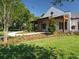 Elegant home featuring a covered porch, well-maintained landscaping, and a welcoming entrance at 15711 Starling Dale Ln, Lithia, FL 33547