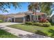 Attractive single-Gathering home with a gray exterior, well-kept lawn, and a three-car garage at 15711 Starling Dale Ln, Lithia, FL 33547