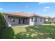 The home's exterior features a covered patio and a grassy yard at 15711 Starling Dale Ln, Lithia, FL 33547
