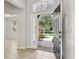Welcoming foyer with an open front door view and a decorative transom window above at 15711 Starling Dale Ln, Lithia, FL 33547