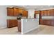 Spacious kitchen featuring granite countertops, wood cabinets, and stainless-steel appliances at 15711 Starling Dale Ln, Lithia, FL 33547