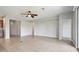 Open-concept living room with tile floors and a ceiling fan transitions to other living spaces at 15711 Starling Dale Ln, Lithia, FL 33547