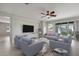 Bright living room boasts neutral walls, recessed lighting, ceiling fan, and sliding doors to the outdoor space at 15711 Starling Dale Ln, Lithia, FL 33547