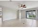 Spacious living room offers plenty of natural light with tile flooring and a ceiling fan at 15711 Starling Dale Ln, Lithia, FL 33547