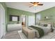 Well-lit primary bedroom with neutral colors and light-colored floors presents a serene retreat at 15711 Starling Dale Ln, Lithia, FL 33547