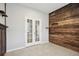 A modern office boasts French doors and an accent wood wall at 15711 Starling Dale Ln, Lithia, FL 33547