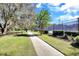 Scenic view of a community park featuring a paved walkway and a tennis court in the background at 15711 Starling Dale Ln, Lithia, FL 33547