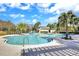 A large, resort-style community swimming pool featuring lounge chairs and lush landscaping at 15711 Starling Dale Ln, Lithia, FL 33547