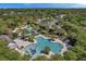 An aerial view highlights a resort-style community with lush landscaping and multiple pools for relaxation at 16618 Kingletside Ct, Lithia, FL 33547