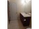 Bathroom featuring a wooden vanity cabinet, light countertop, and a tiled floor at 16618 Kingletside Ct, Lithia, FL 33547