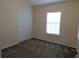 Bedroom with closet, neutral carpet, and a window at 16618 Kingletside Ct, Lithia, FL 33547