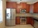Modern kitchen featuring stainless steel appliances, tile floor and a large side-by-side refrigerator at 16618 Kingletside Ct, Lithia, FL 33547