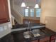 View from kitchen featuring open concept to the living room with stainless steel sink and granite counter at 16618 Kingletside Ct, Lithia, FL 33547