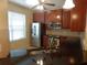 Kitchen with stainless steel appliances, dark wood cabinetry, and black granite countertops at 16618 Kingletside Ct, Lithia, FL 33547