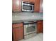 Close up of modern stainless-steel oven and microwave, complete with tiled backsplash at 16618 Kingletside Ct, Lithia, FL 33547