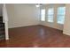 Bright living room featuring laminate flooring, multiple windows, and a staircase to the second floor at 16618 Kingletside Ct, Lithia, FL 33547
