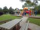 Community playground with a covered picnic area and benches with green space at 16618 Kingletside Ct, Lithia, FL 33547