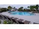 Community pool featuring lounge chairs, splash pad, and poolside seating at 16618 Kingletside Ct, Lithia, FL 33547