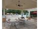 Relax in this poolside cabana with comfortable seating and a ceiling fan, perfect for enjoying sunny days at 16618 Kingletside Ct, Lithia, FL 33547